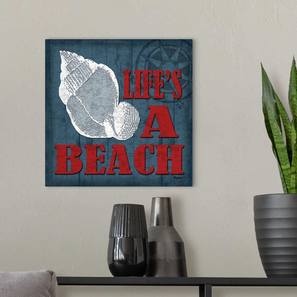 A modern room featuring "Life's a beach" square beach decor in blue, red, and white.