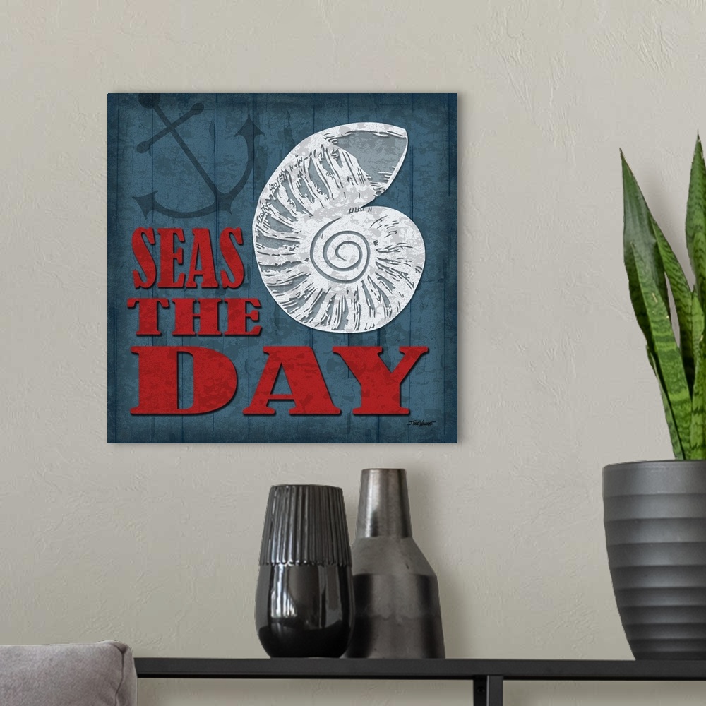 A modern room featuring "Seas the day" square beach decor in blue, red, and white.