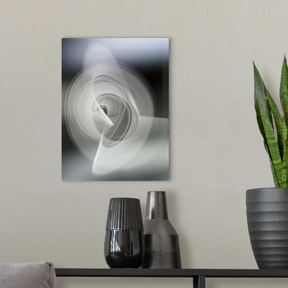A modern room featuring Light trails creating an abstract white swirling circle pattern on a gray background