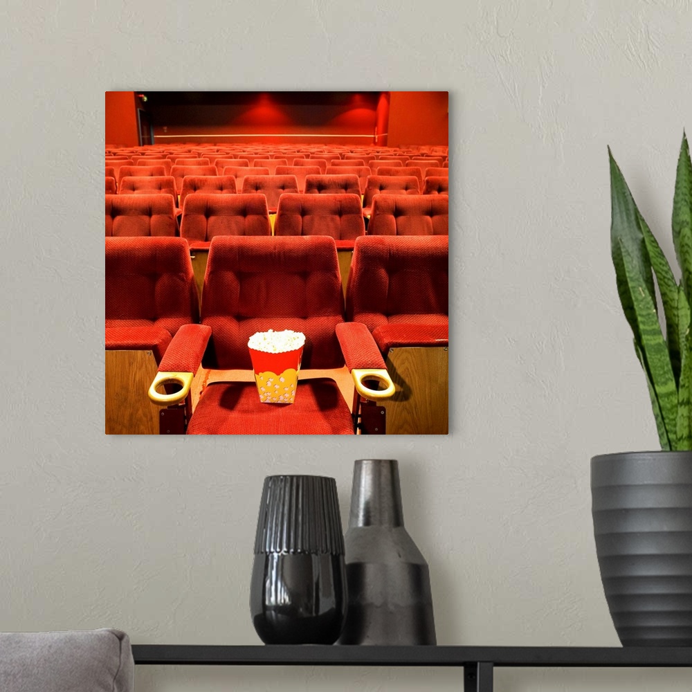 A modern room featuring Popcorn on the seat in a cinema