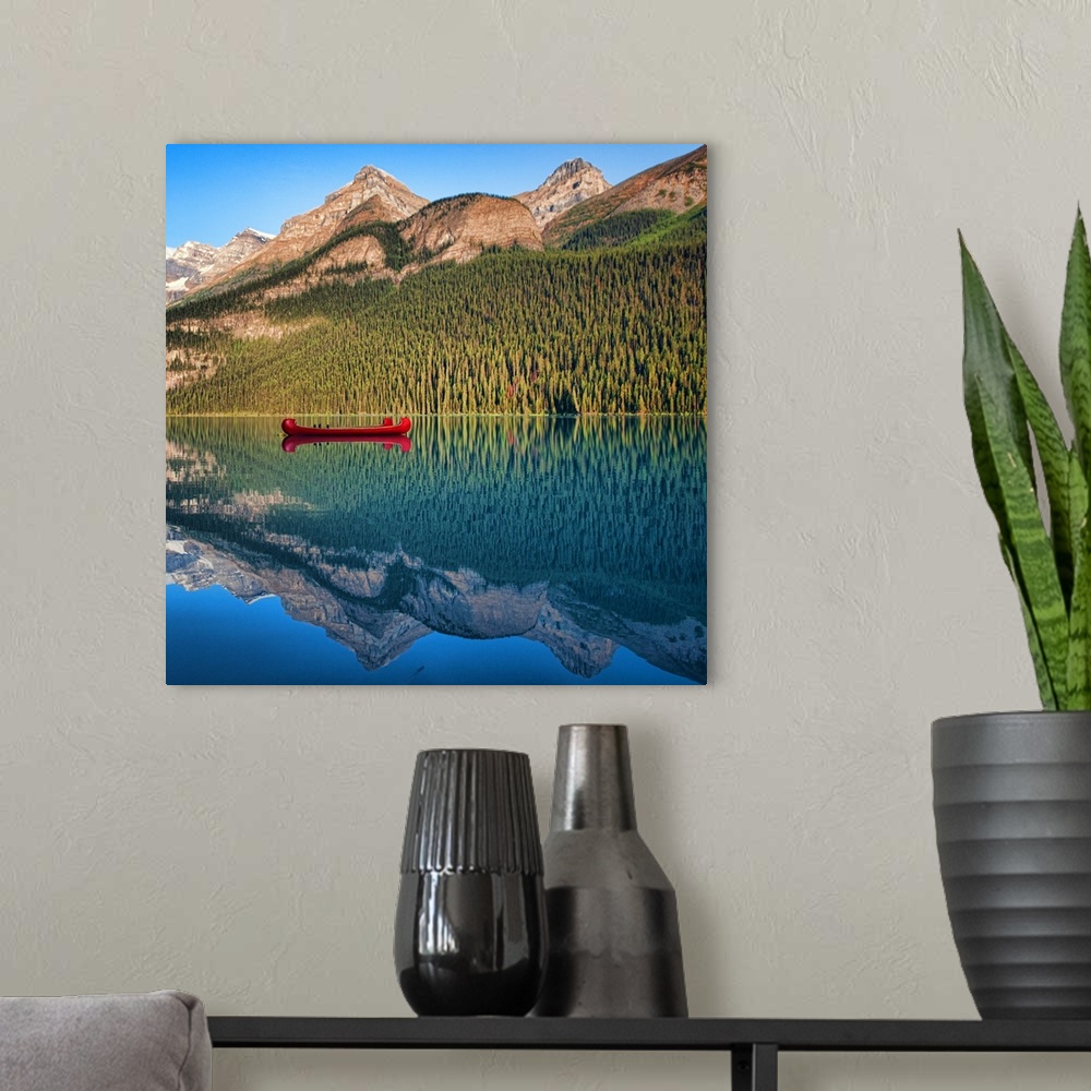 A modern room featuring Reflection of mountain and boat in lake Louise, Banff, Alberta.