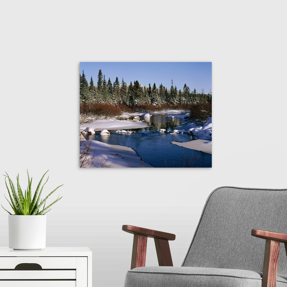 A modern room featuring River with snow-covered banks and trees