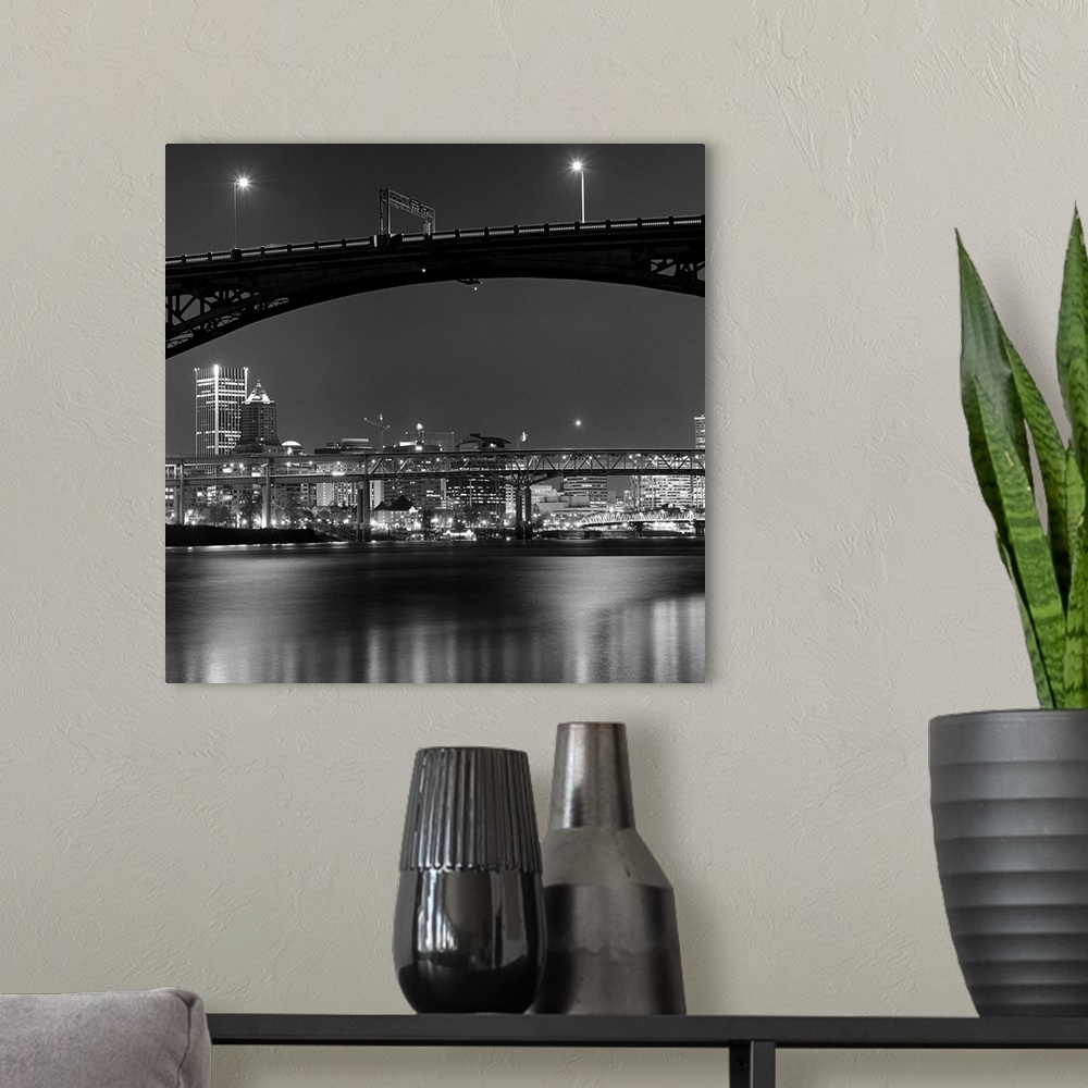 A modern room featuring Ross Island bridge at night with city of Portland, Oregon in background, US.