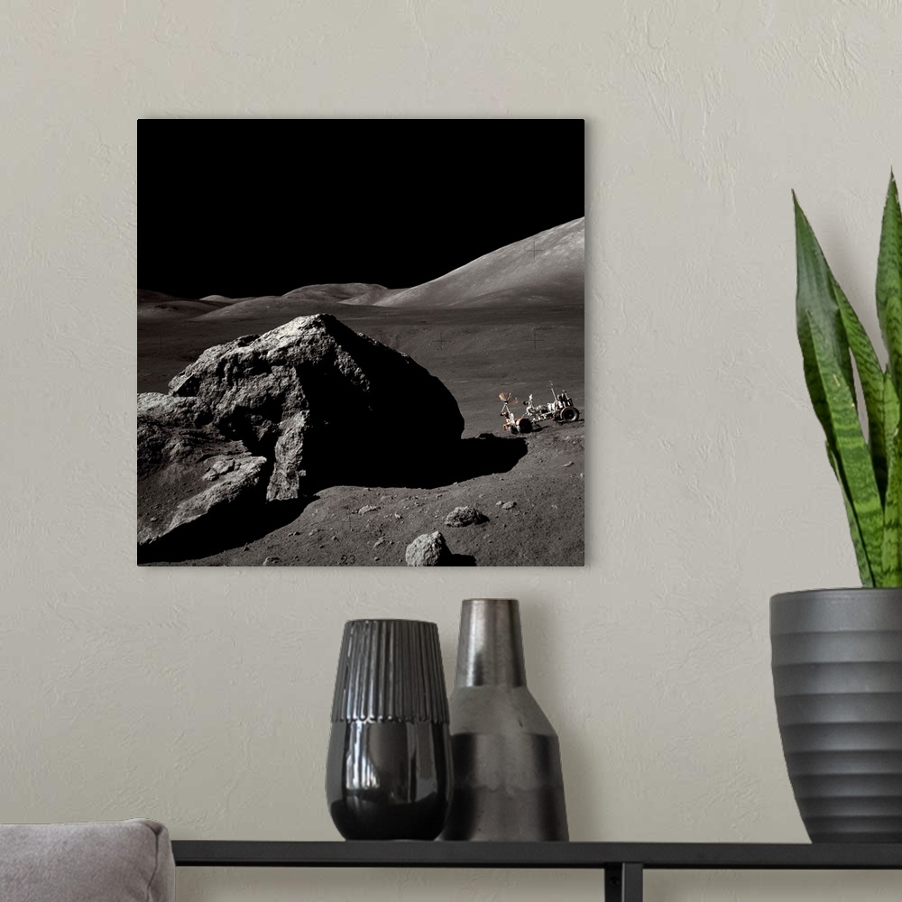 A modern room featuring The Apollo 17 lunar rover sits on a slope near a large rock in the Moon's Taurus-Littrow Valley. ...