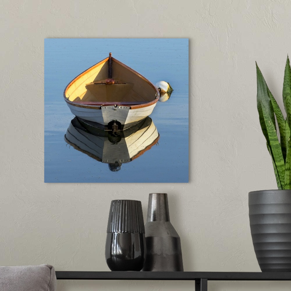 A modern room featuring beautiful wooden skiff (boat, dinghy) photographed from the back with a reflection in water - a b...