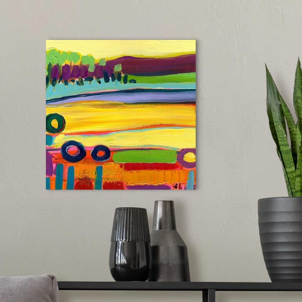 A modern room featuring Large square contemporary art of a colorful landscape that includes fields in the foreground and ...