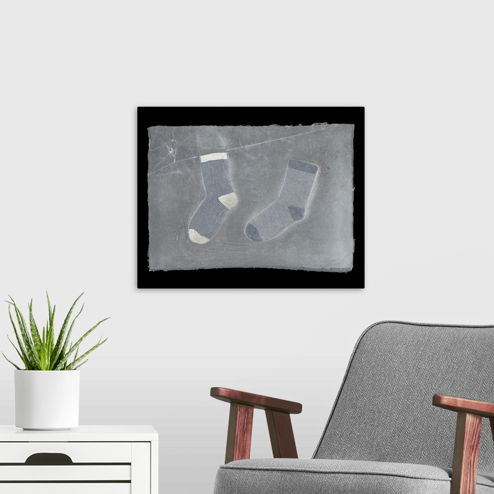 A modern room featuring Two striped children's socks suspended in handmade paper.