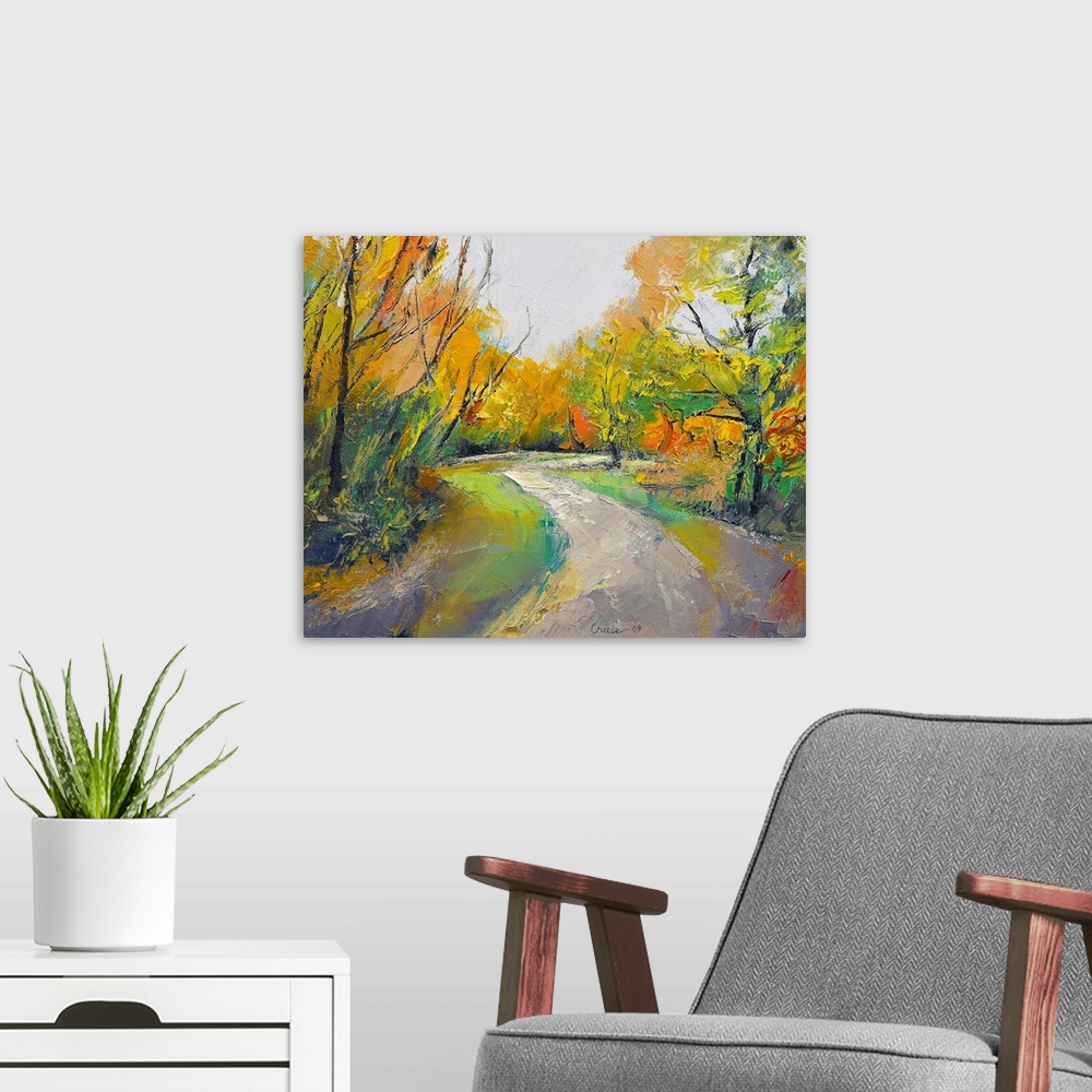 A modern room featuring Painting of a road in the middle of a forest in the fall.