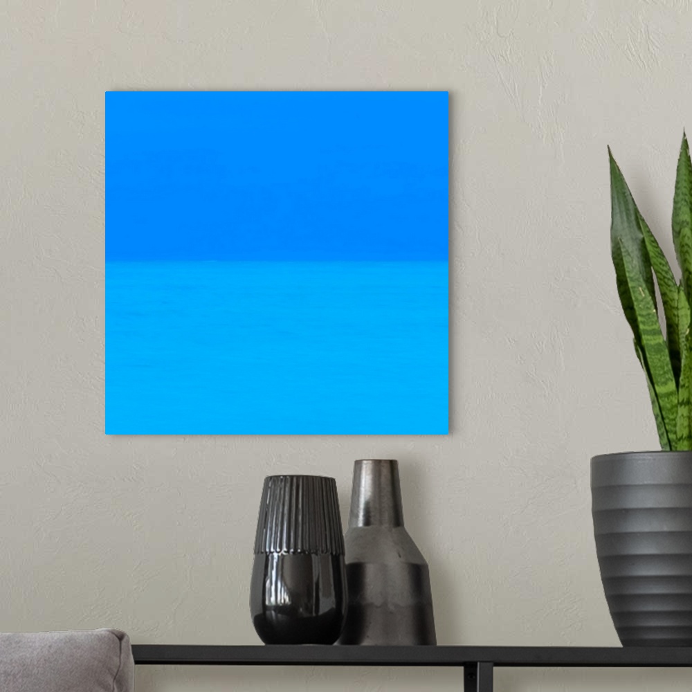 A modern room featuring Abstract photograph of two layers of deep blue.