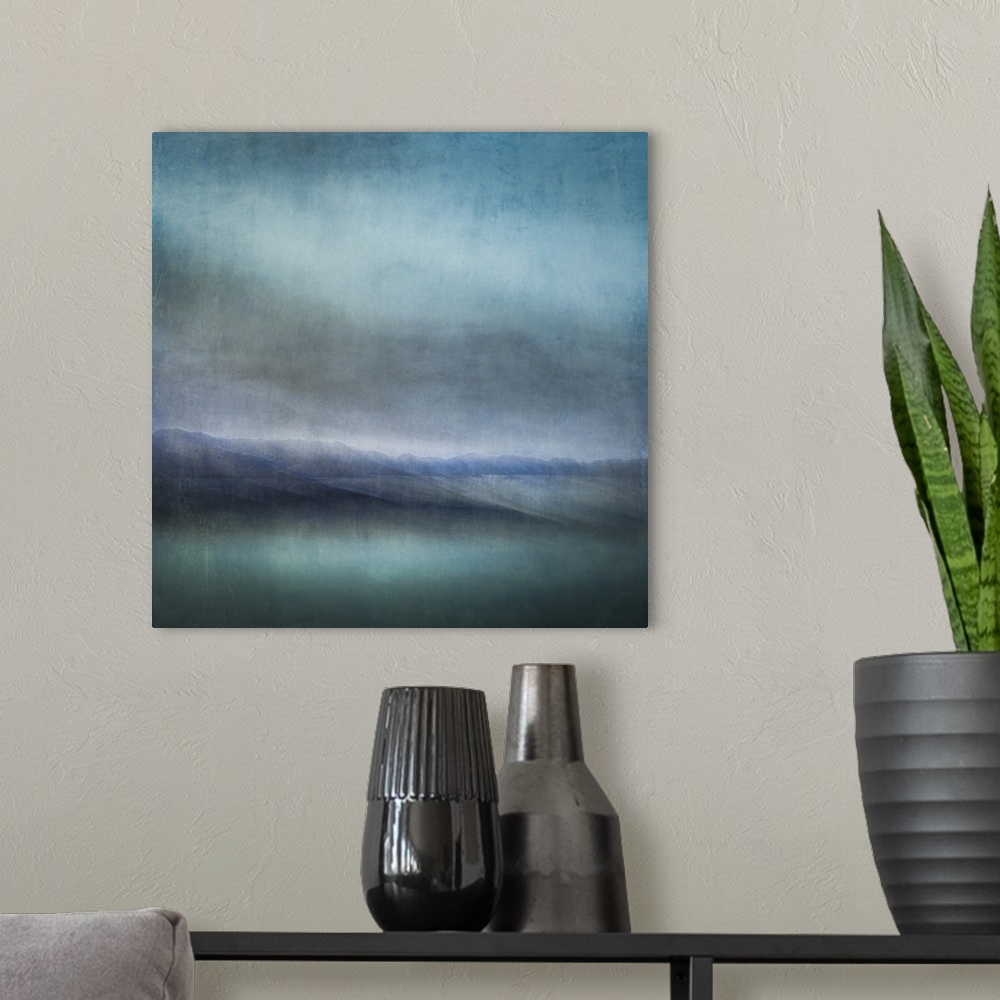 A modern room featuring Blue landscape abstract of tiny islands receding into the distance with moody skies and dark teal...