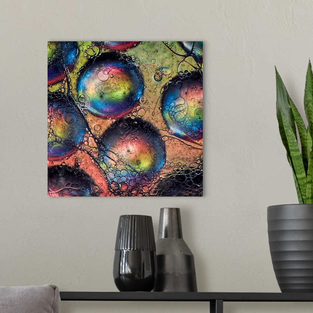 A modern room featuring An abstract fine art photo of several bubbles with rainbow colors.