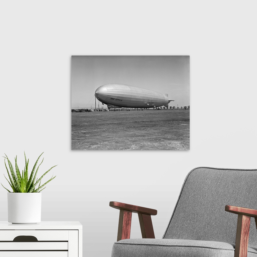 A modern room featuring 1920's German Rigid Airship Graf Zeppelin D-Lz-127 Moored Being Serviced By Small Crew October 10...