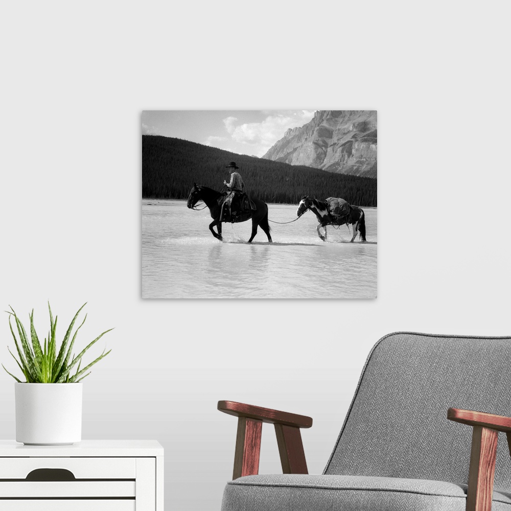A modern room featuring 1930s 1940s Cowboy On Horseback Crossing River With 2nd Horse In Tow.