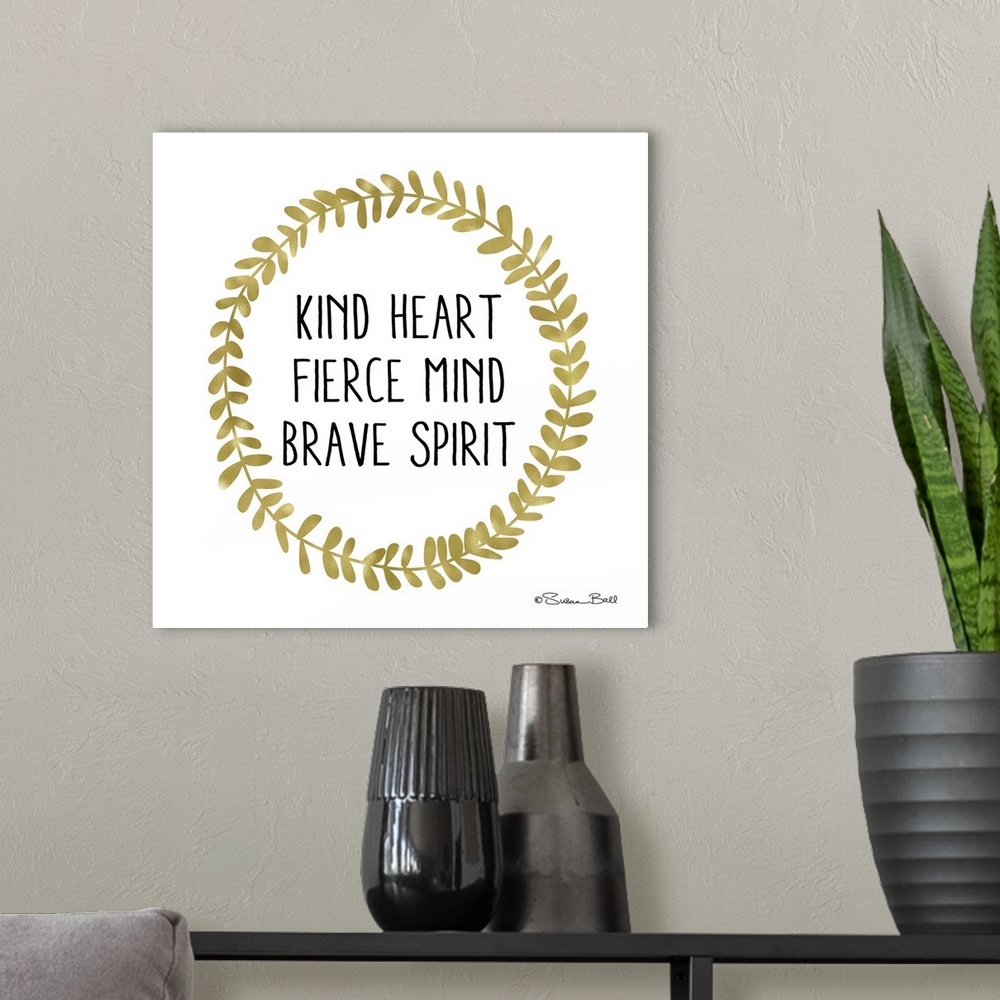 A modern room featuring Inspirational sentiment framed by a  gold wreath of laurel leaves.