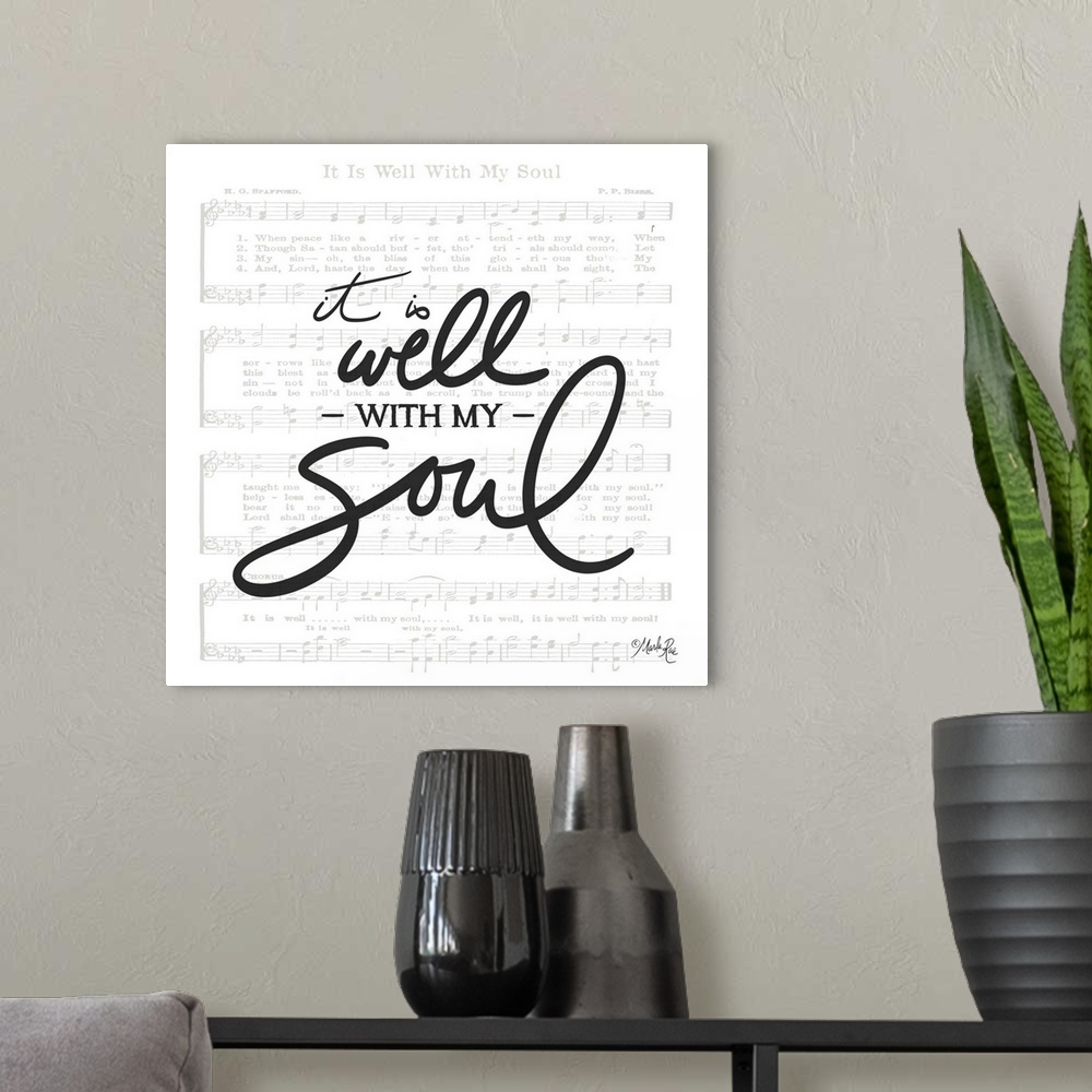 A modern room featuring Typography of the phrased "it is well with  my soul" with the sheet music for It is Well with My ...