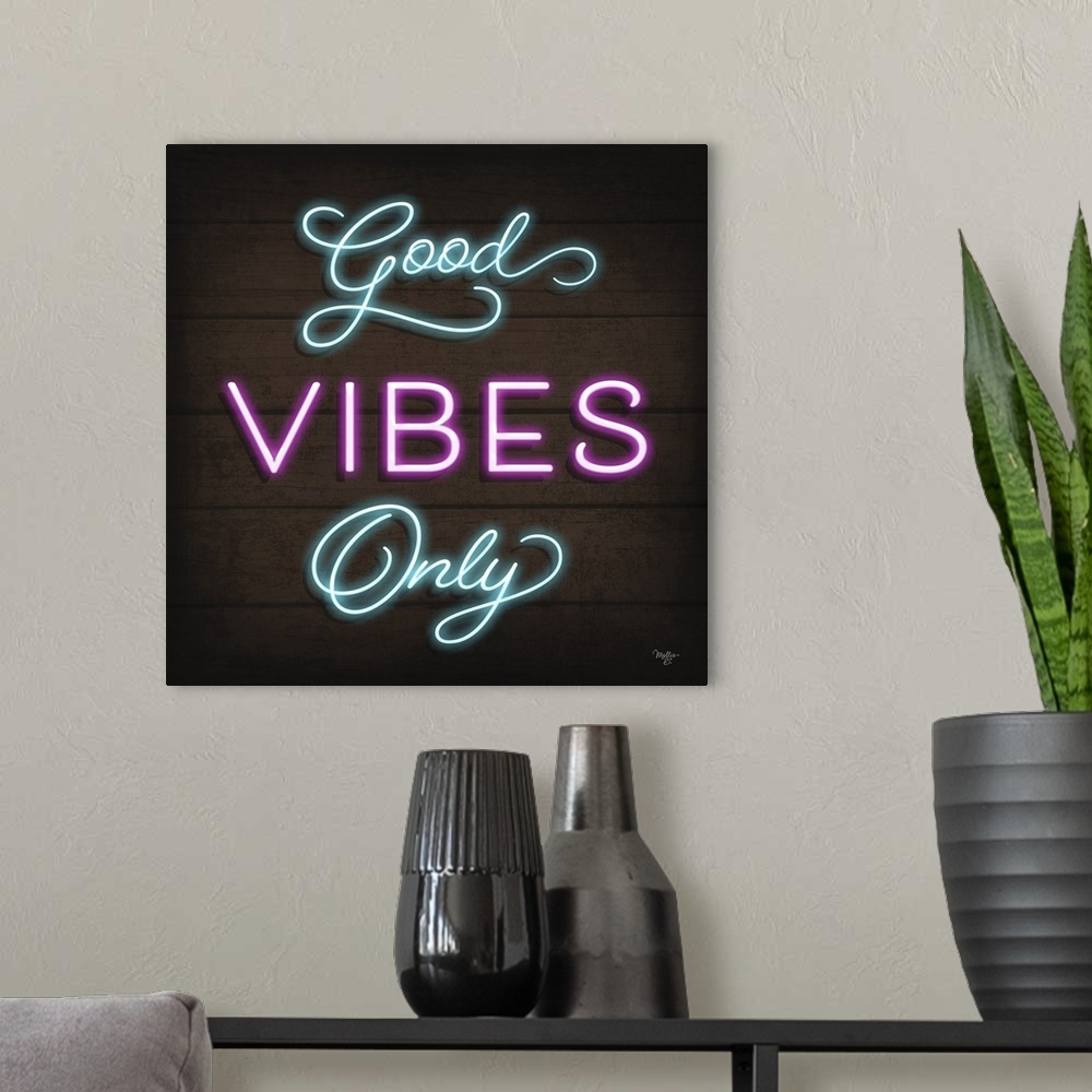 A modern room featuring Retro sign resembling neon lights which reads "Good Vibes Only."