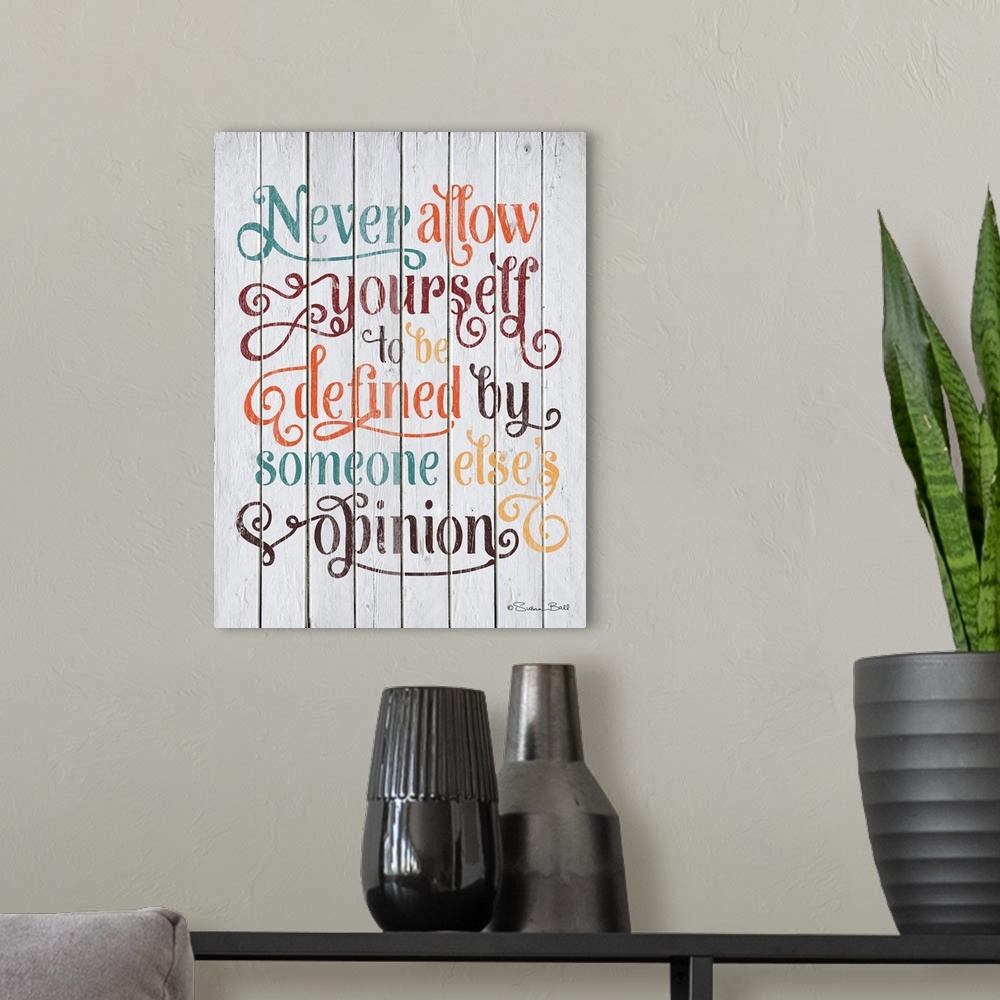 A modern room featuring Inspirational quote in text embellished with lots of flourishes and curls, on a wooden board back...