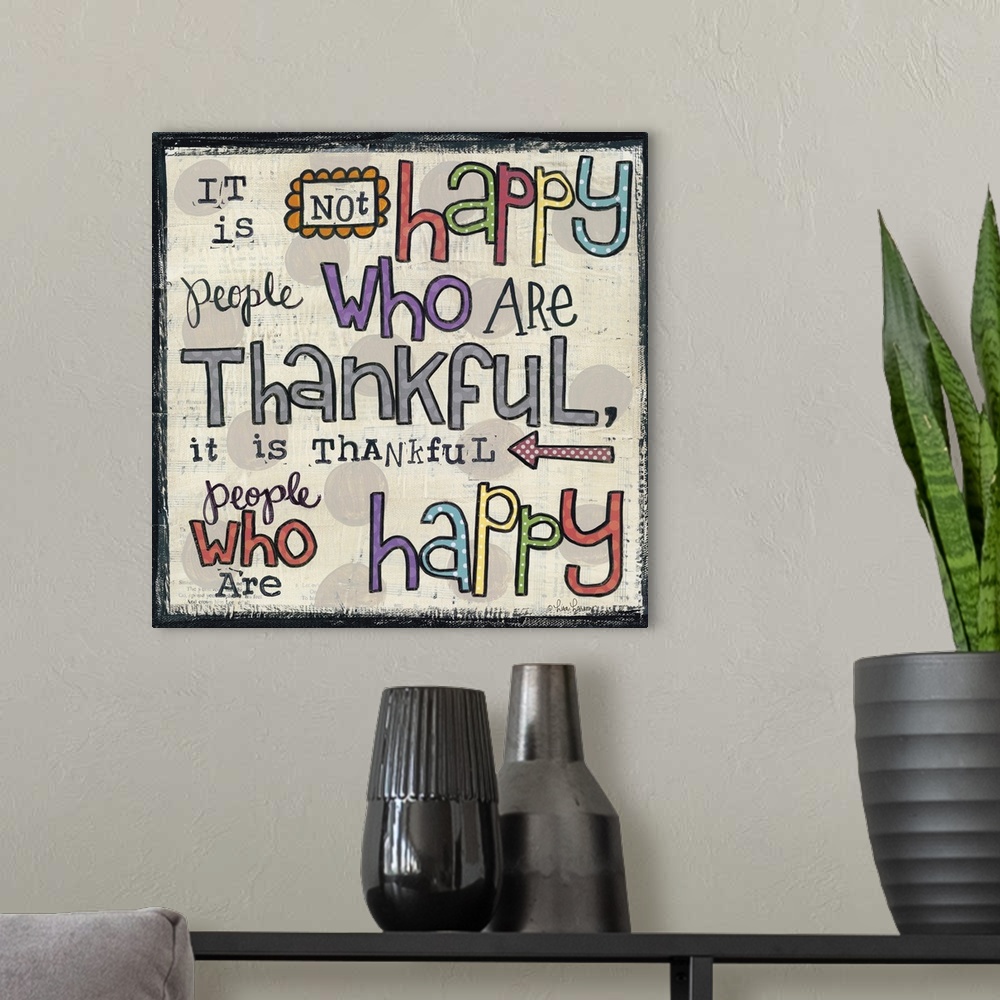 A modern room featuring Handwritten typography art reading "It is not happy people who are thankful, it is thankful peopl...