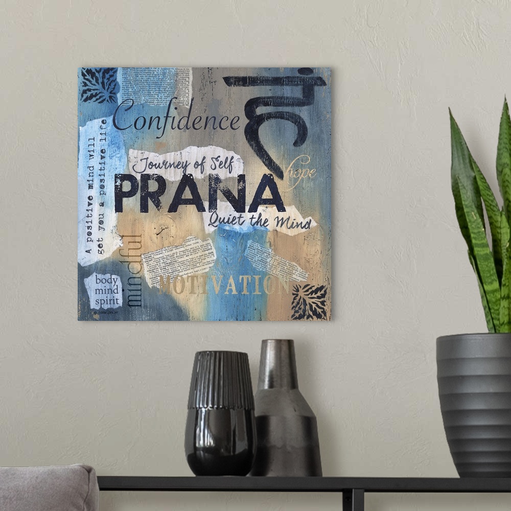 A modern room featuring Artwork of yoga-themed words, phrases, and symbols on blue and tan.