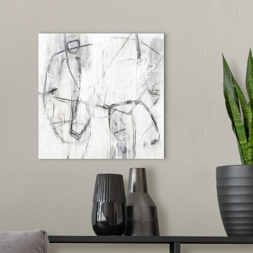 A modern room featuring Square painting with abstract figures created with loose lines in shades of gray and white.