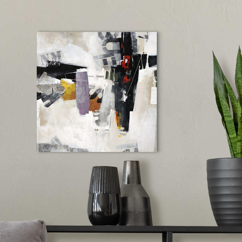 A modern room featuring Abstract art of overlapping stenciled letters and pieces of newsprint, placed randomly among patc...