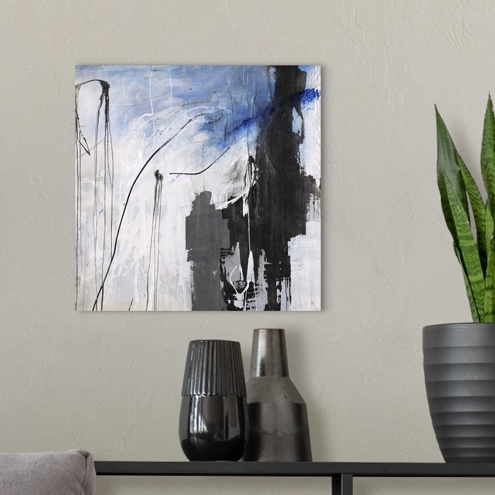 A modern room featuring Contemporary abstract painting using blue and black pops of color against a neutral background.