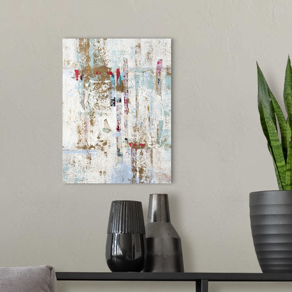 A modern room featuring Abstract painting with a white background and gold, light blue, and red hues on top.