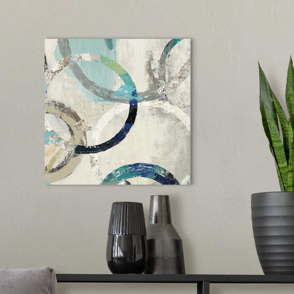 A modern room featuring Abstract artwork of overlapping rings in shades of white, cream, and teal.