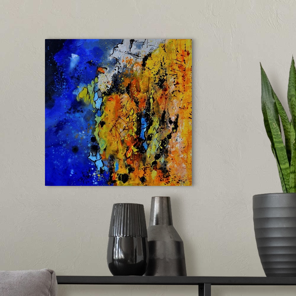 A modern room featuring A square abstract painting with vibrant colors of blue, orange and yellow.