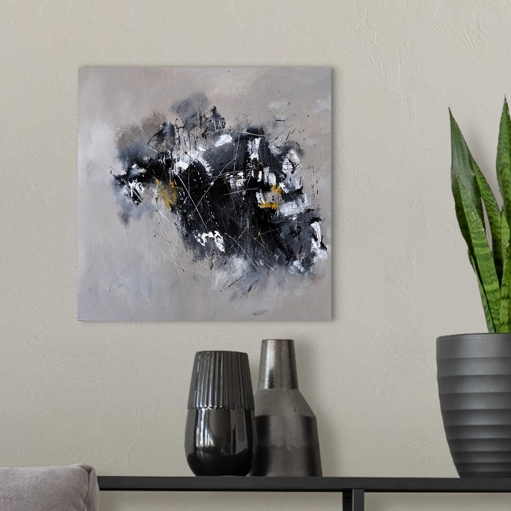 A modern room featuring A square abstract painting in textured shades of black and gray with splatters of paint overlapping.