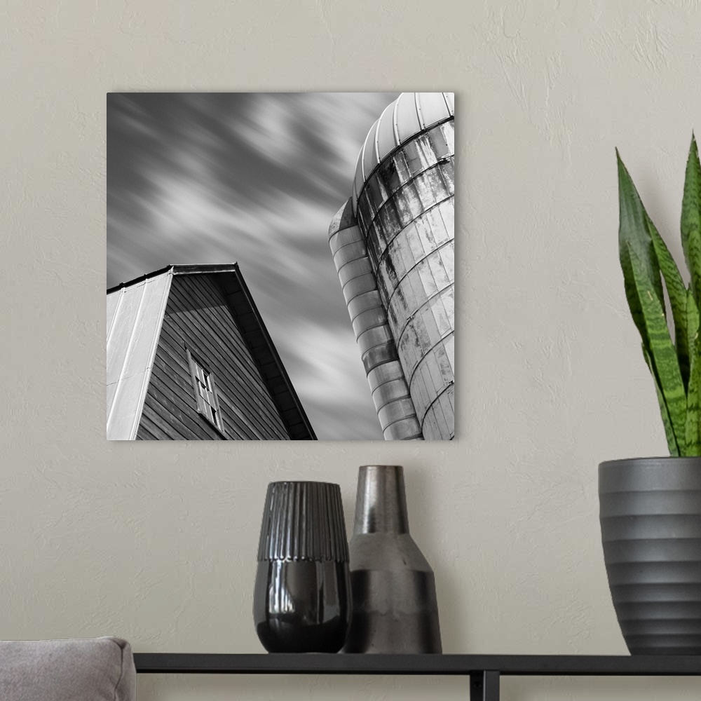 A modern room featuring A black and white image of a barn and silo with a blurred clouded sky.