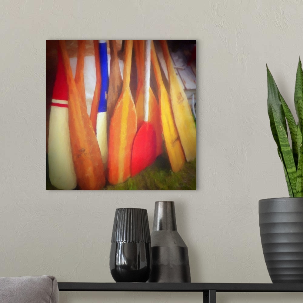 A modern room featuring Square contemporary painting of bright, colorful boat oars leaning together.