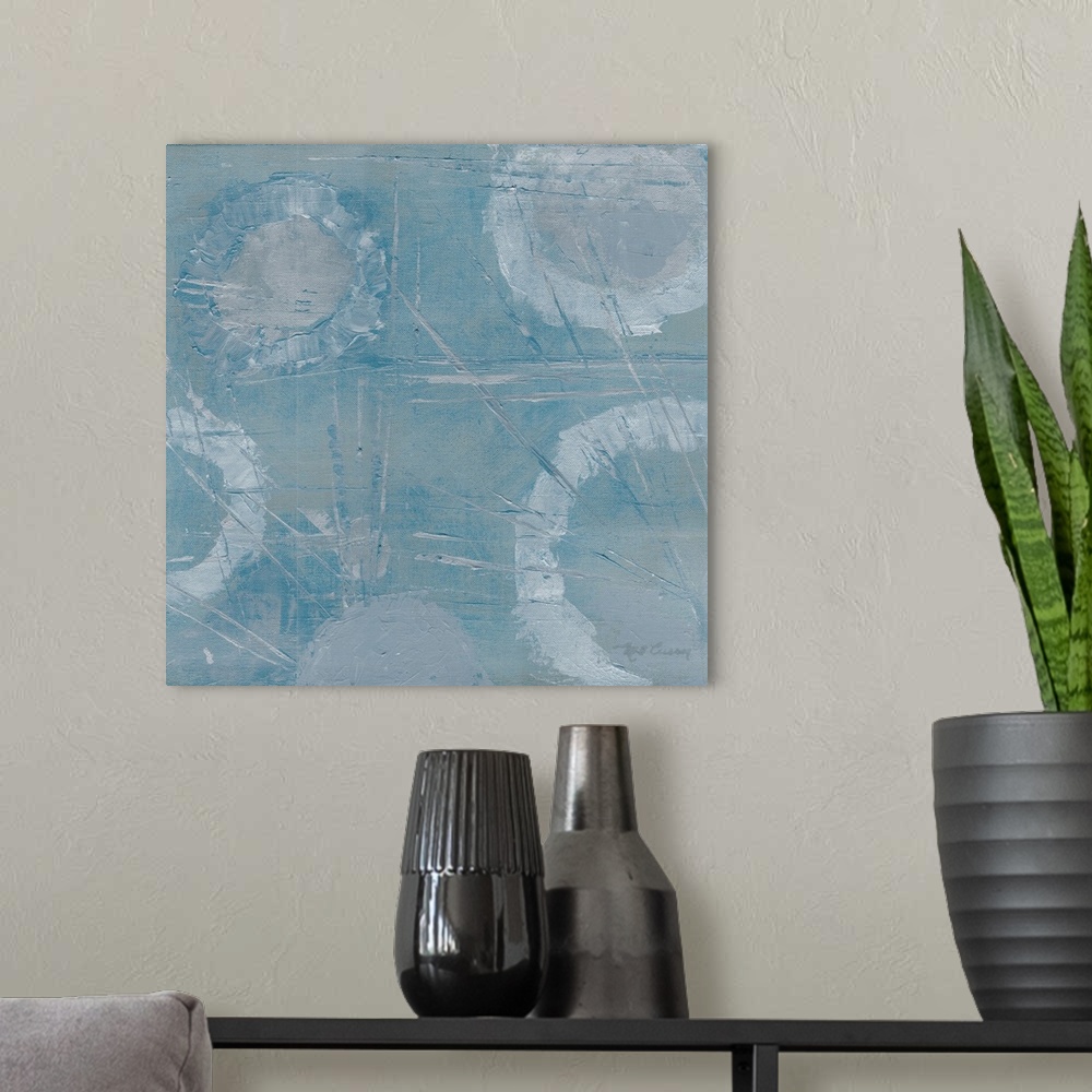 A modern room featuring Square abstract painting of textured faded white rings with thin angled streaks on a light blue b...