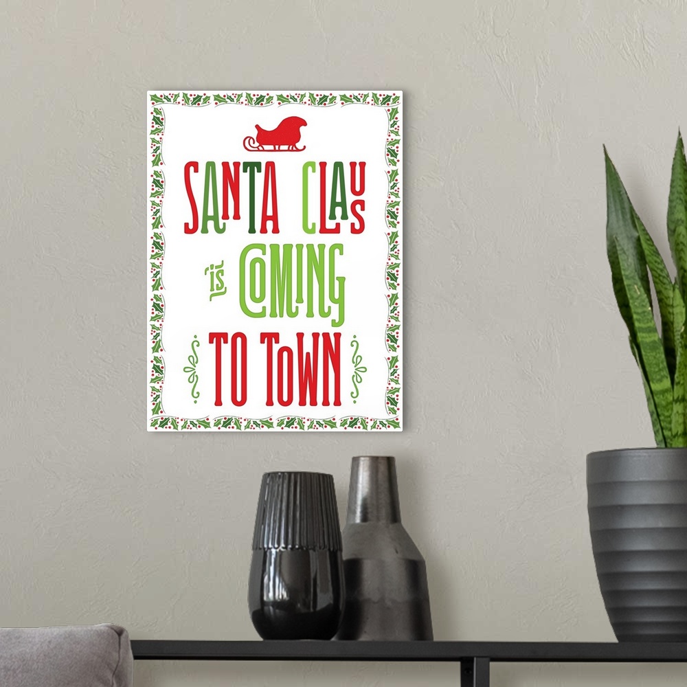A modern room featuring "Santa Clause Is Coming To Town" in green and red with a holly border.