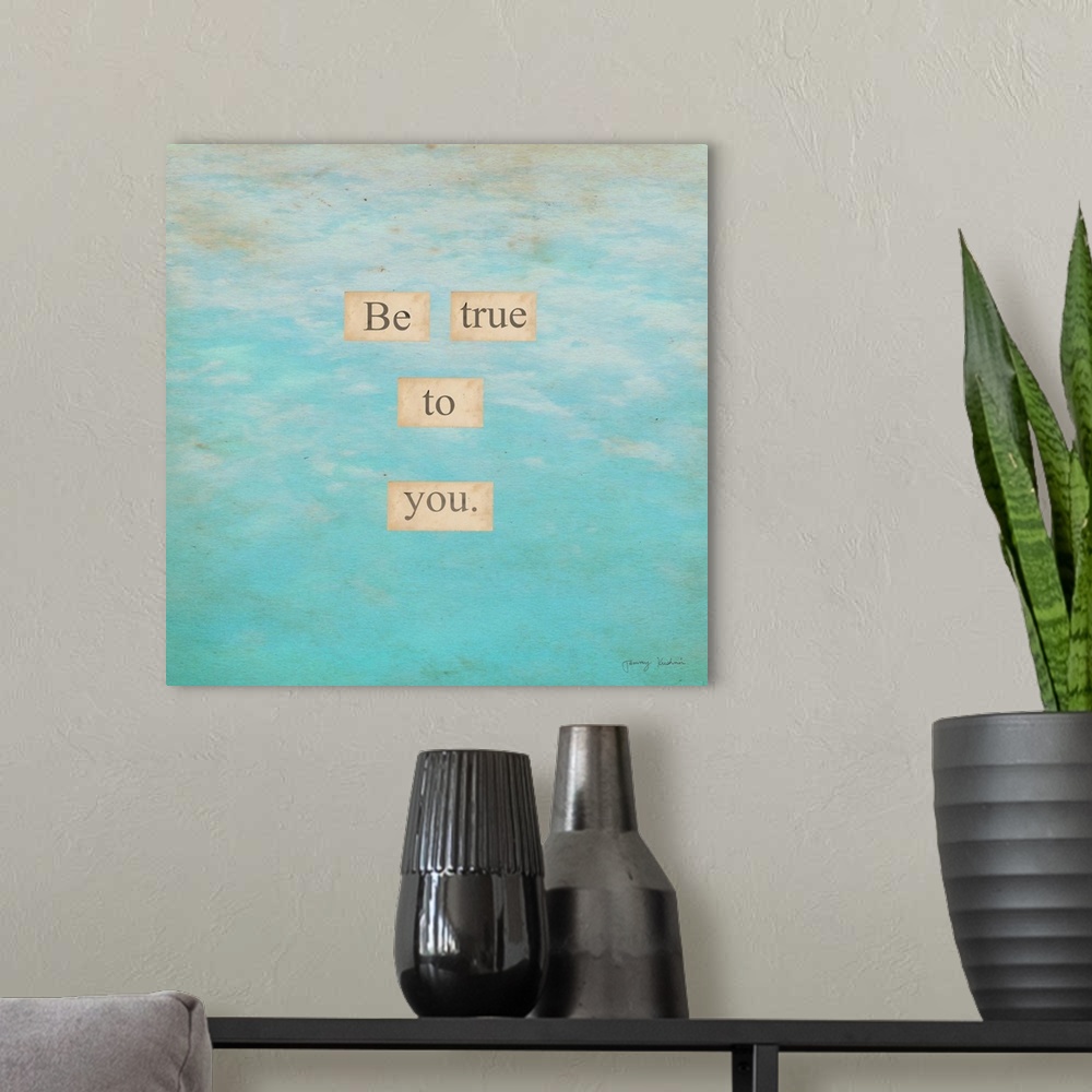 A modern room featuring "Be True To You." in small squares overlapping in faded blue to white sky background.