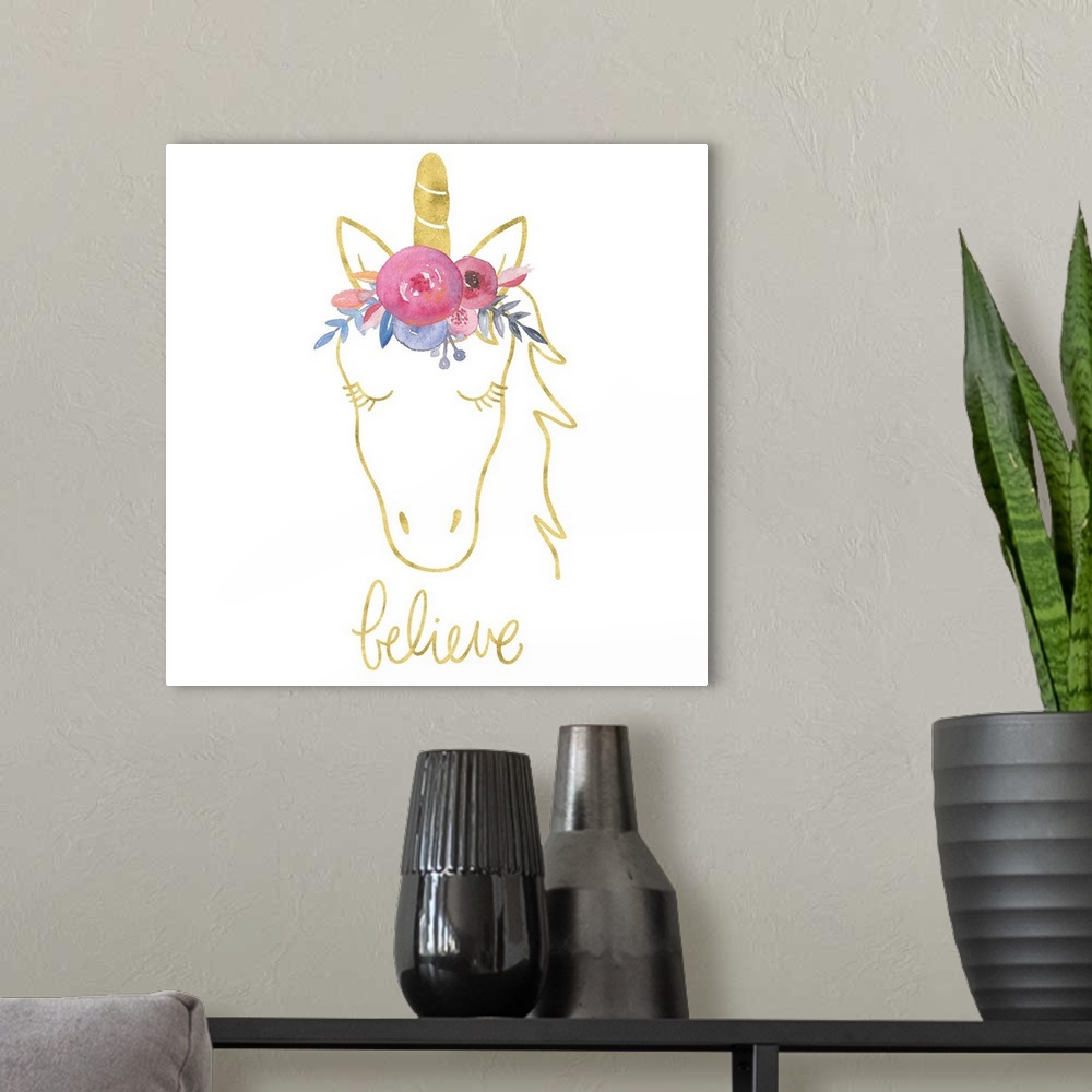 A modern room featuring "Believe" with a drawing of an unicorn in gold with colorful flowers on top of it's head.