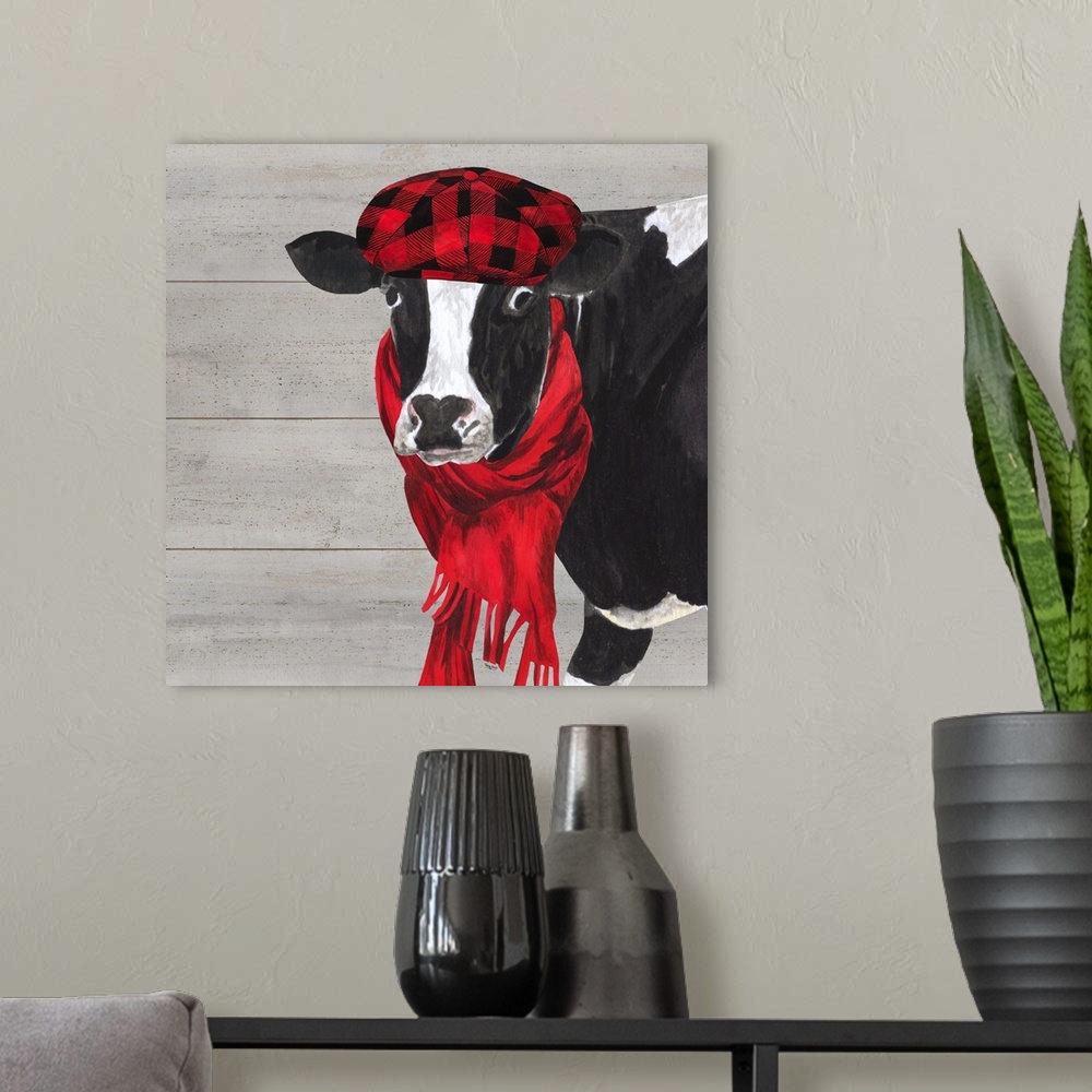 A modern room featuring A black and white cow with a hat and scarf around her neck against of grey wood background.