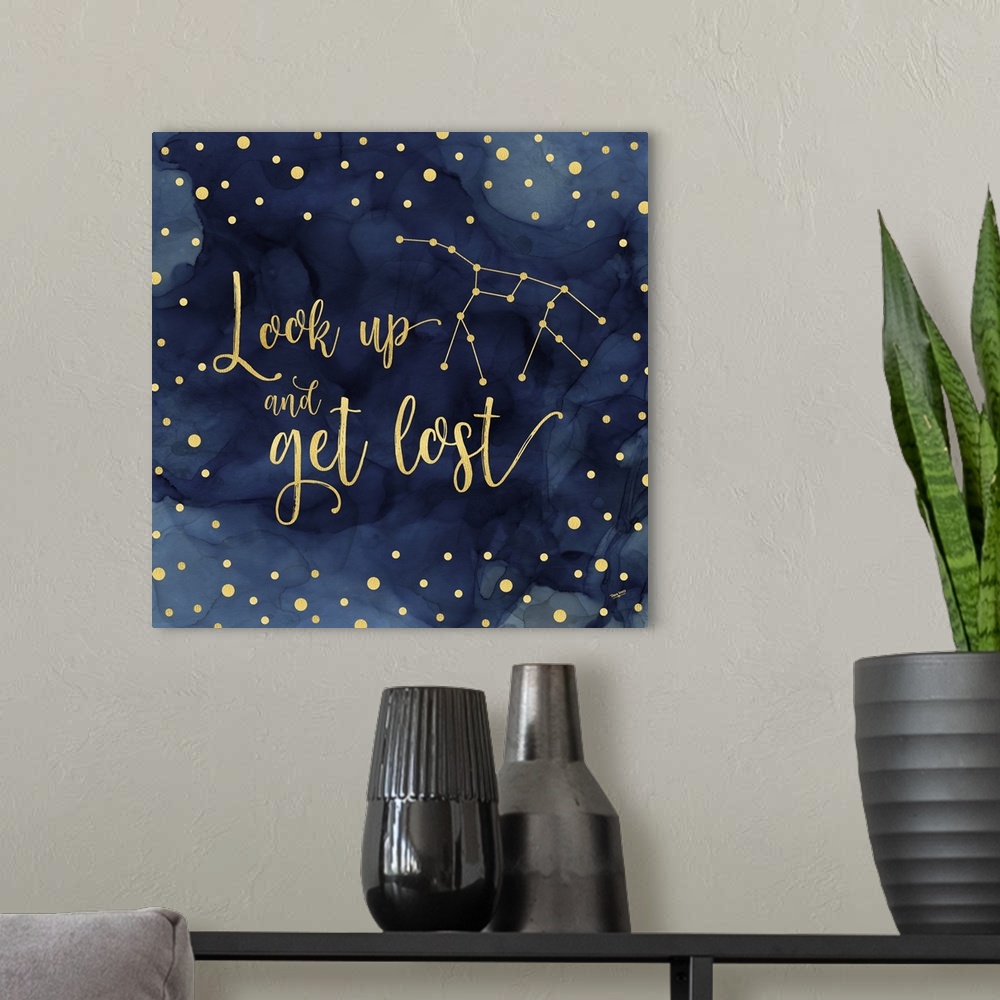 A modern room featuring "Look up and get lost" on a blue water-colored background with gold spots.