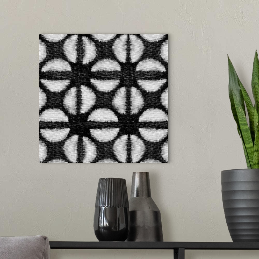 A modern room featuring Decorative design of rows of white circles with lines going through them on black linen.