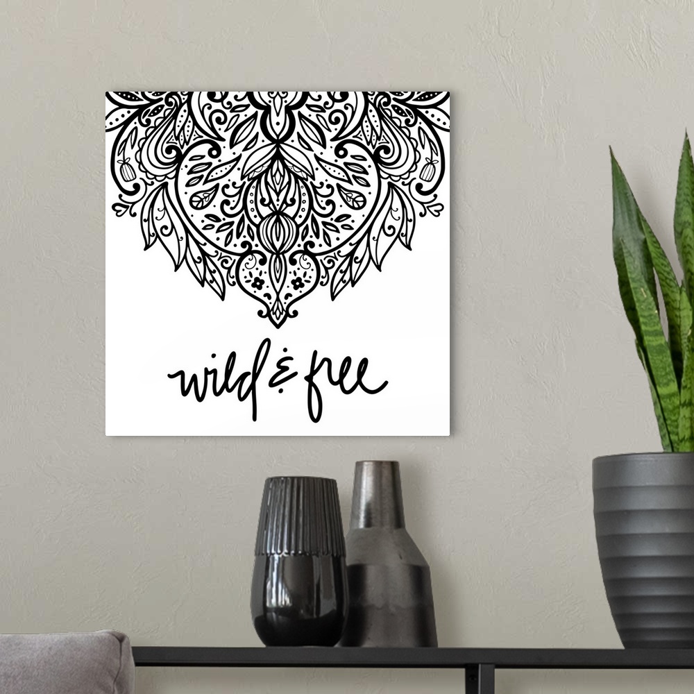 A modern room featuring "Wild & Free" with a elaborate mandala design in black on a white background.