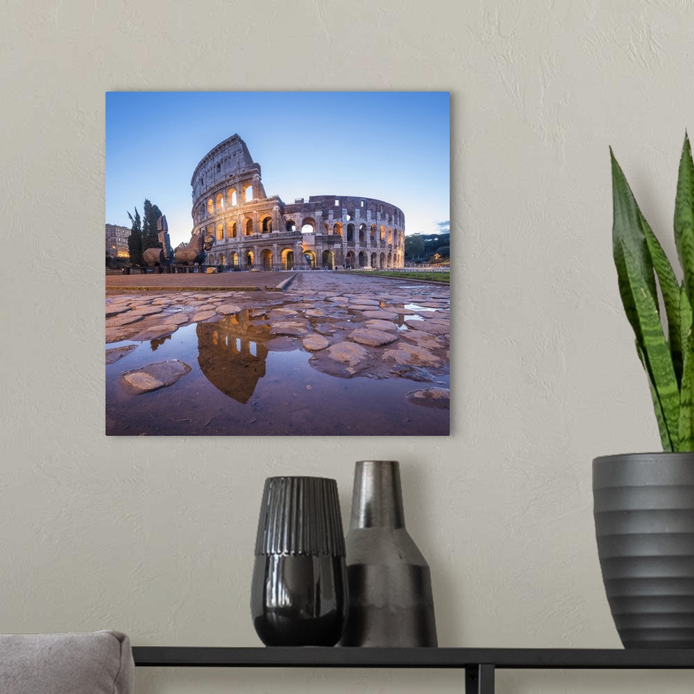A modern room featuring The Colosseum, reflected in a puddle at dusk, Rome, Lazio, Italy