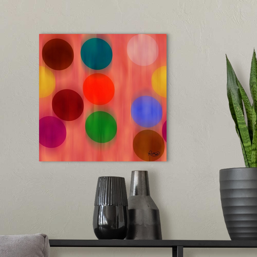 A modern room featuring Square abstract art with a pink background and faded falling circles in different colors.