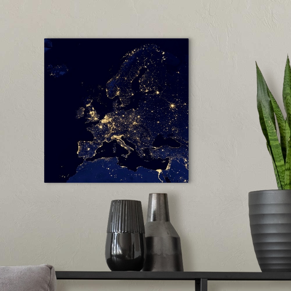 A modern room featuring Europe at night. Black marble satellite image of Europe at night. More densely populated areas ar...
