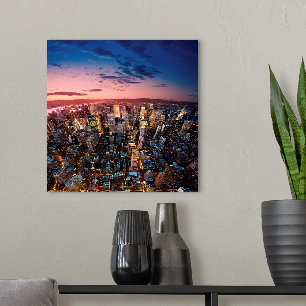 A modern room featuring Amazing aerial view of Manhattan at dusk, New York City.