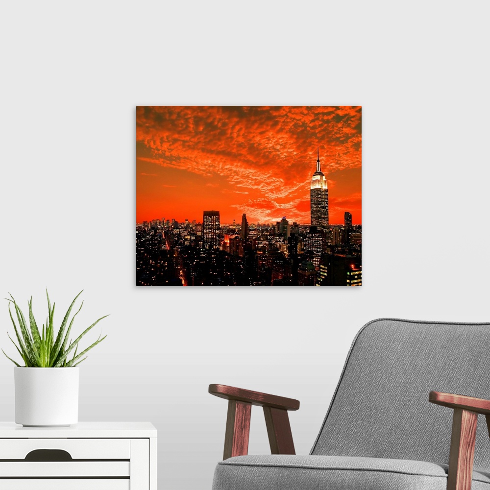 A modern room featuring The New York City midtown skyline under dramatic clouds.