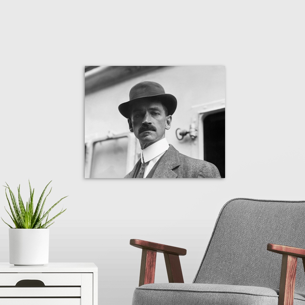 A modern room featuring American history photograph of Glenn Curtiss in an undated portrait.