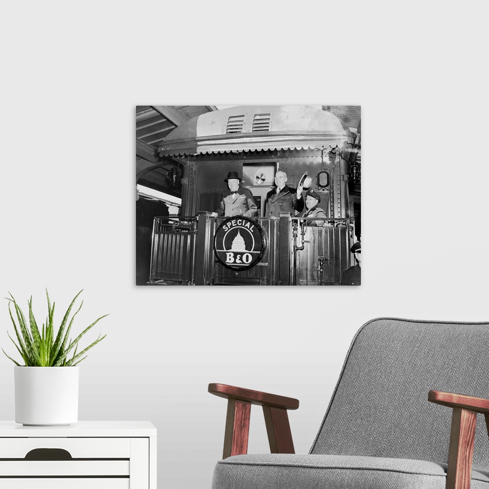 A modern room featuring President Harry Truman and Prime Minister Winston Churchill on the rear platform of a train, circ...