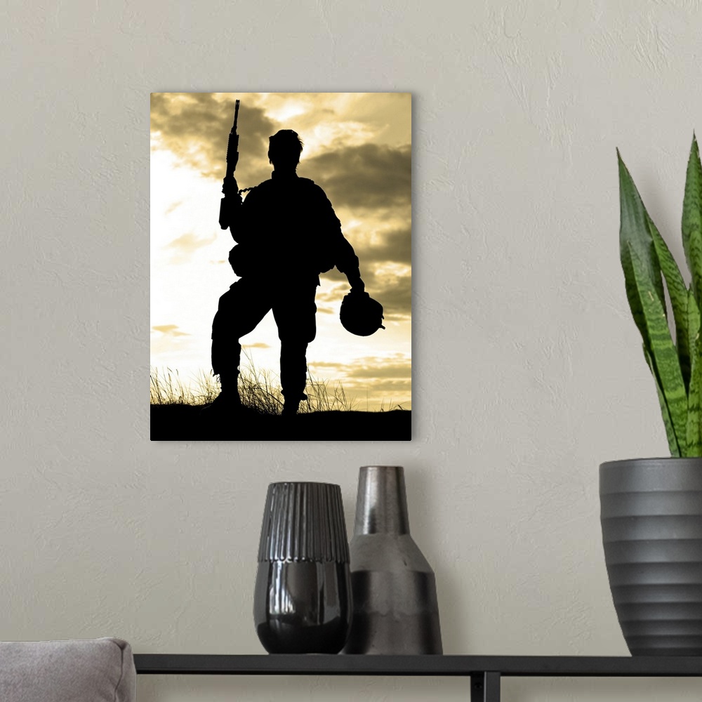 A modern room featuring Silhouette of U.S. soldier with rifle against a sunset.