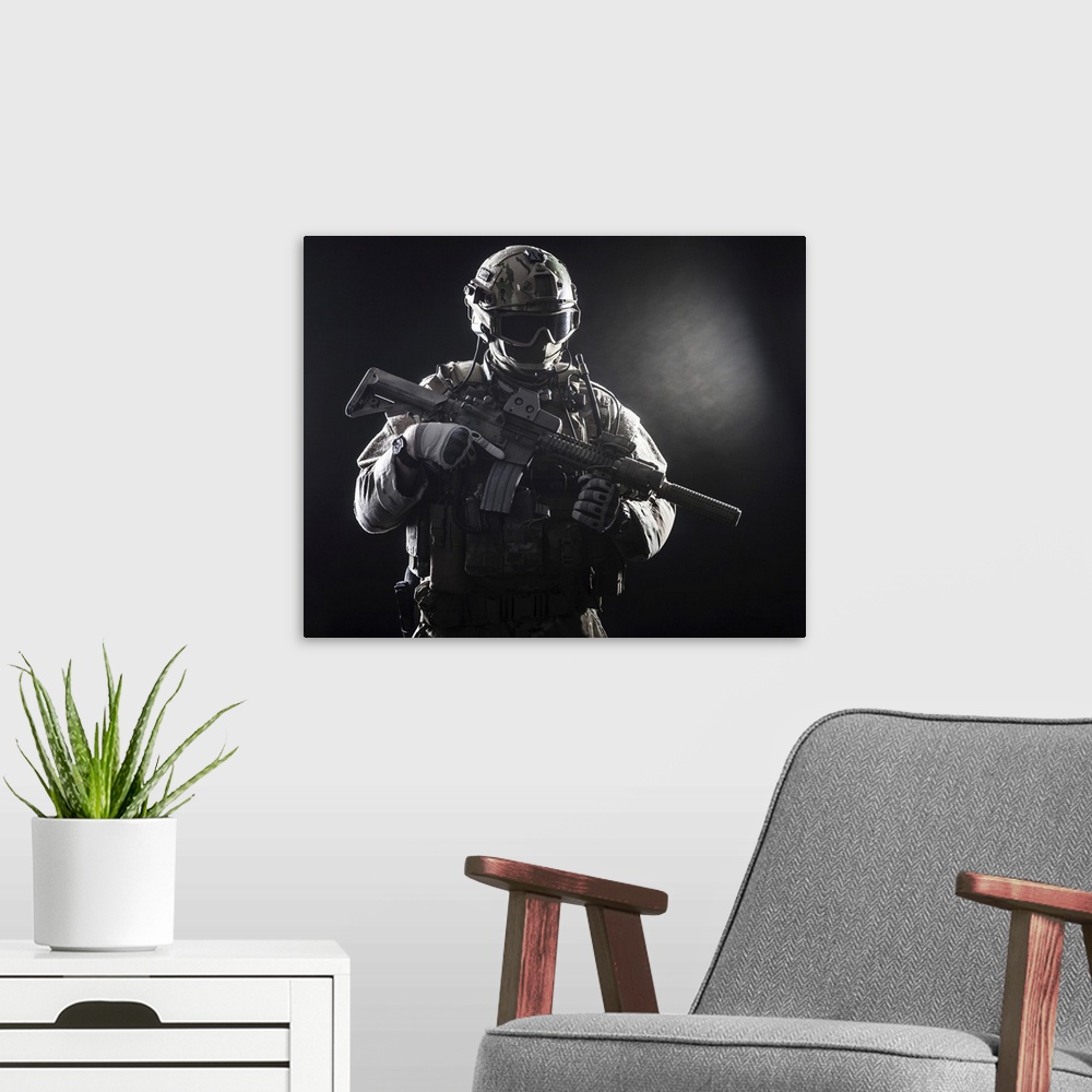 A modern room featuring Special forces soldier with rifle on dark background.