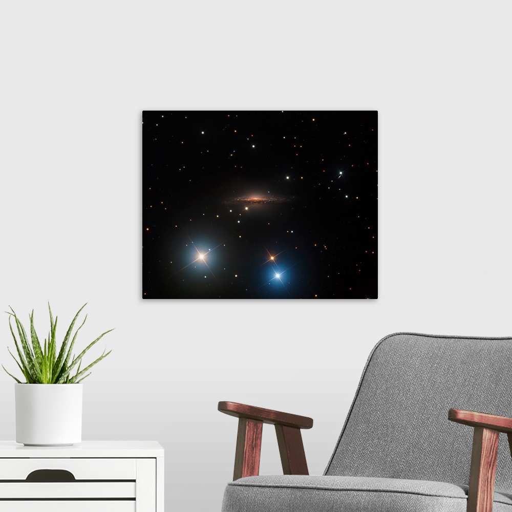 A modern room featuring Spiral galaxy NGC 1055.